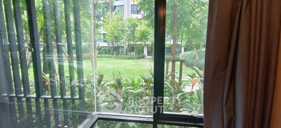 Charming garden view from a cozy apartment window, perfect for nature lovers seeking tranquility.