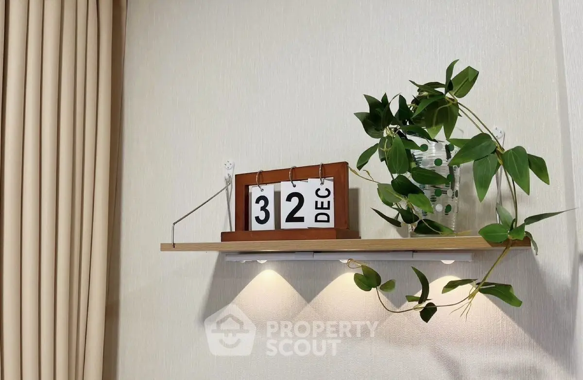 Stylish interior shelf with calendar and plant, perfect for modern living room decor.
