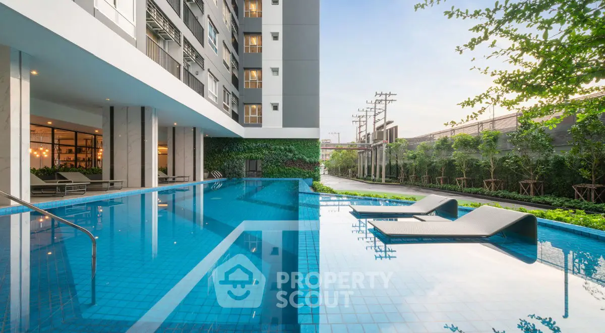 Luxurious modern apartment complex with stunning outdoor pool and lush greenery.