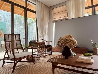 Stylish living room with modern wooden furniture and large windows for natural light.