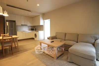 Spacious modern living room with open kitchen and cozy seating area