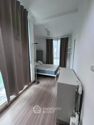 Modern bedroom with large windows and minimalist decor