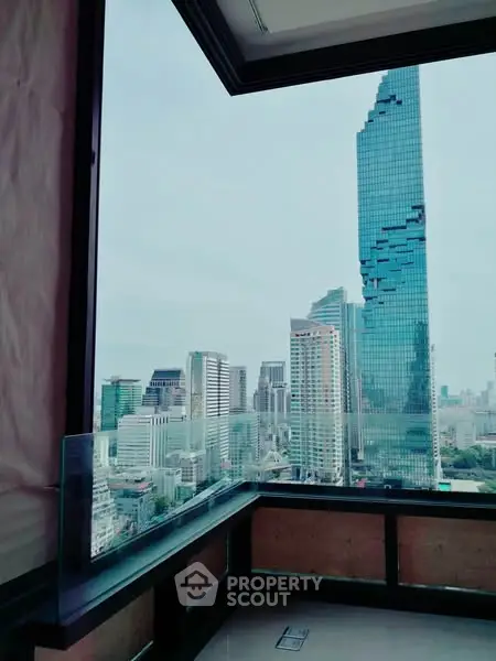 Stunning cityscape view from a high-rise balcony with modern architecture.