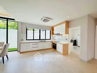 Spacious modern kitchen with open layout and large windows for natural light.
