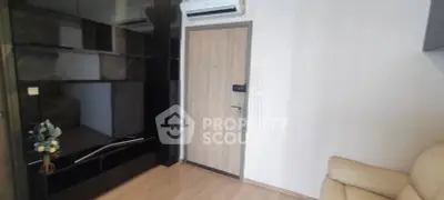 Modern living room with sleek black cabinetry and air conditioning