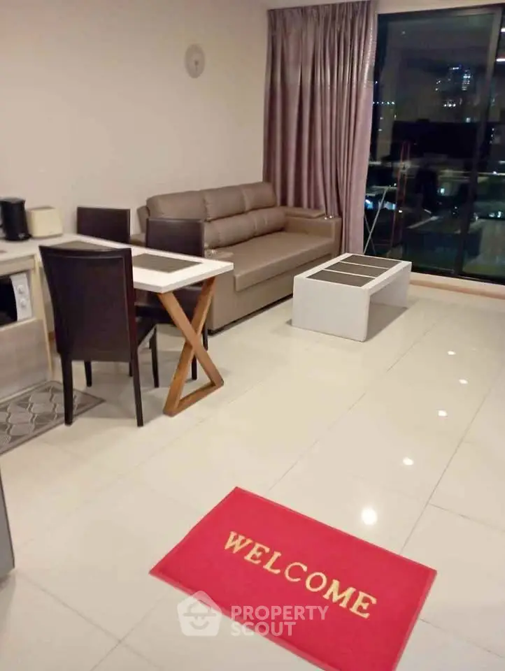Modern living room with sleek furniture and city view, featuring a welcoming ambiance.