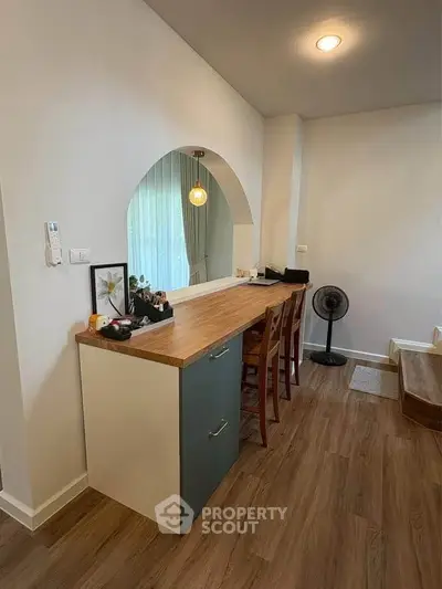 Stylish modern interior with wooden flooring and sleek furniture in a cozy living space.