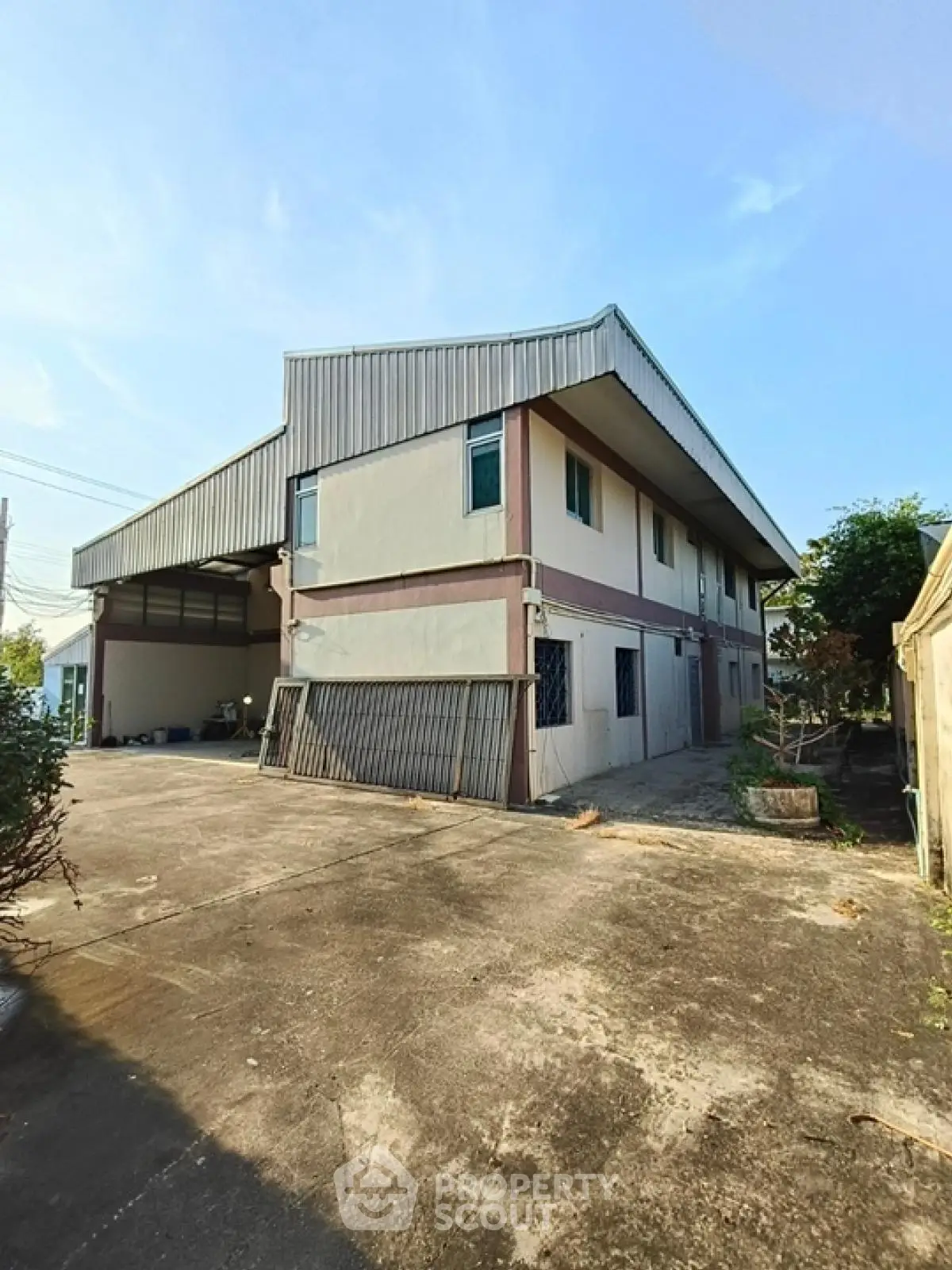 Spacious industrial building with ample outdoor space and modern design
