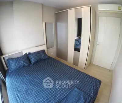 Modern bedroom with stylish wardrobe and cozy bedding in a contemporary apartment.
