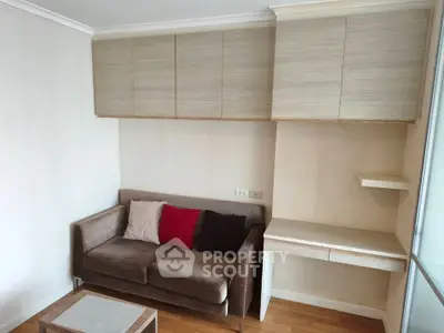 Cozy living room with modern sofa and built-in storage cabinets, perfect for compact urban living.