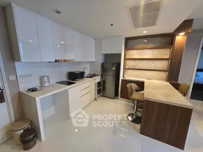 Modern kitchen with sleek cabinets and marble countertop in luxury apartment