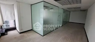 Spacious office space with glass partitions and natural light