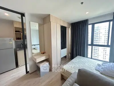 Modern bedroom with city view, featuring sleek furniture and natural light.