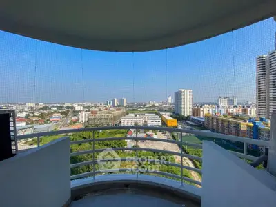 Stunning cityscape view from a high-rise balcony with modern railing design.