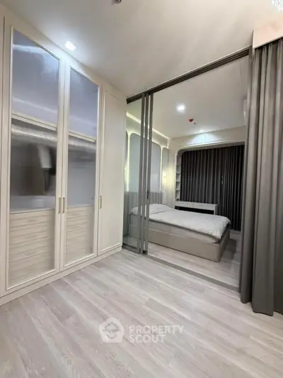 Modern bedroom with sliding glass doors and spacious wardrobe