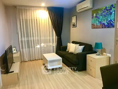 Cozy living room with modern decor, featuring a comfortable sofa, air conditioning, and stylish lighting.