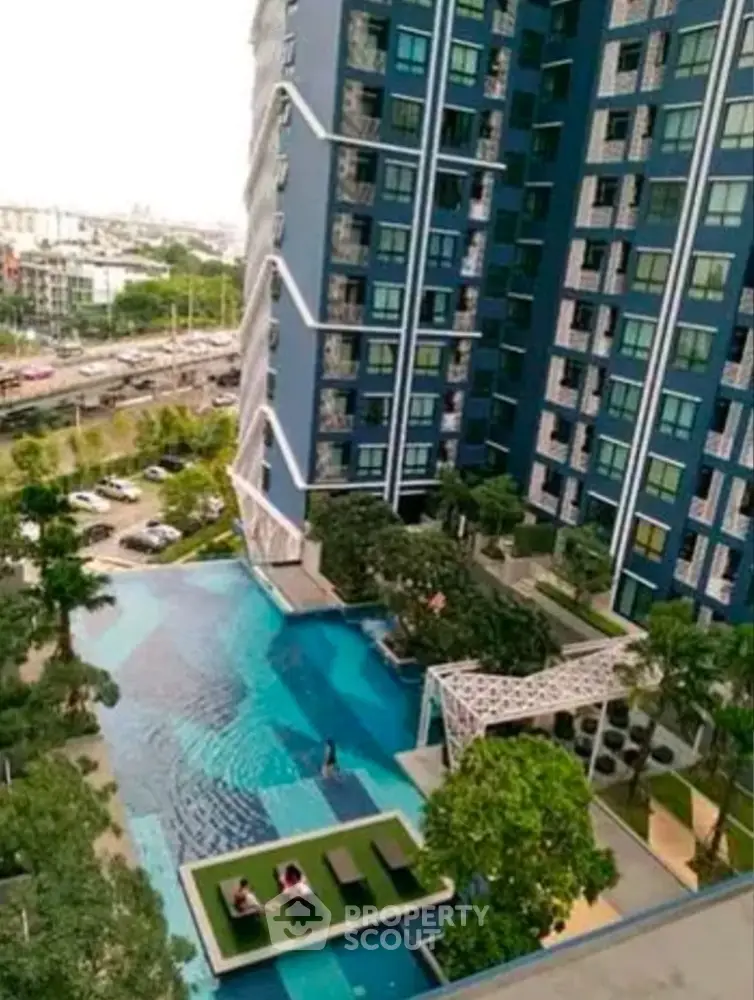 Luxurious high-rise building with stunning pool and lush greenery, offering urban living with serene views.