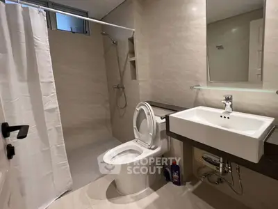 Modern bathroom with sleek fixtures and walk-in shower in a contemporary home.