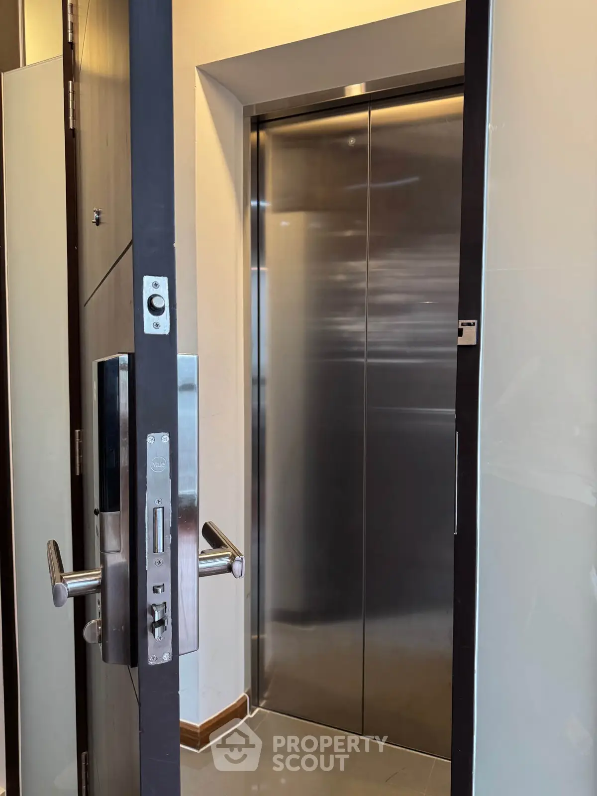 Modern elevator entrance with sleek metal doors in a contemporary building