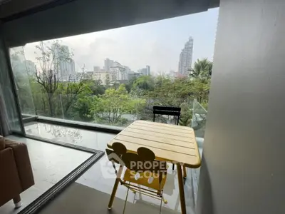 Modern apartment with stunning city view from balcony, featuring stylish outdoor seating.