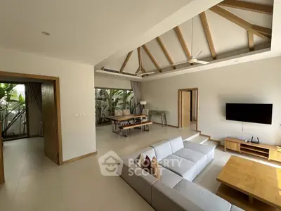 Spacious modern living room with high ceilings and elegant wooden beams