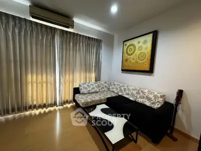 Stylish living room with modern decor and natural light, featuring a chic sectional sofa and elegant artwork.
