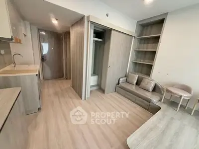 Modern studio apartment with open layout and sleek wooden finishes.