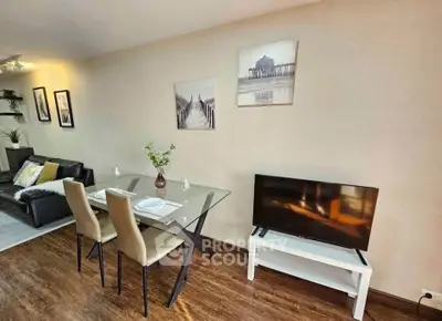 Modern living room with glass dining table and cozy seating area, perfect for urban living.