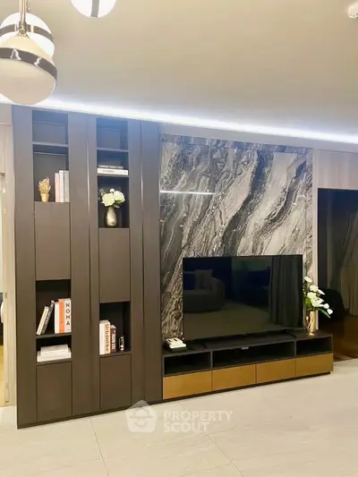 Luxurious living room with modern entertainment center and elegant decor