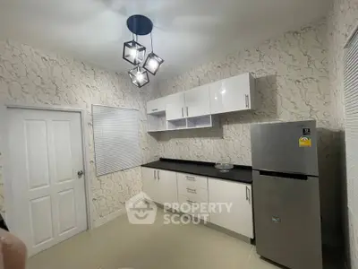 Modern kitchen with sleek cabinets and stainless steel fridge