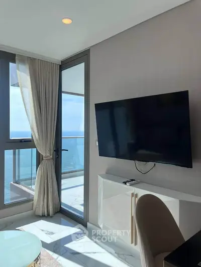 Luxurious living room with ocean view and modern TV setup