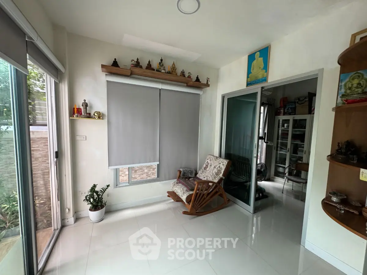 Cozy living room with rocking chair and modern decor, perfect for relaxation.