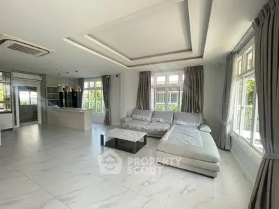 Spacious modern living room with large windows and elegant decor