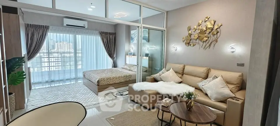 Modern studio apartment with open layout, cozy living area, and stylish bedroom.