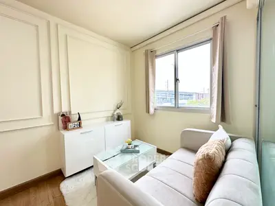 Cozy living room with elegant decor and natural light, featuring a plush sofa and modern coffee table.