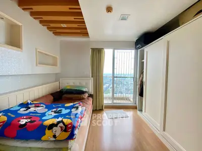 Cozy bedroom with vibrant bedding and city view from window