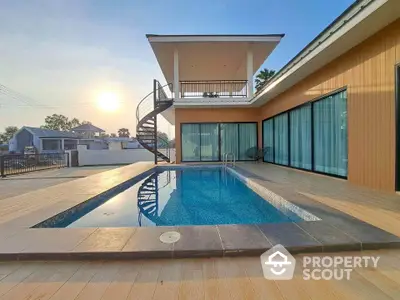 Modern luxury home with private pool and spacious balcony at sunset