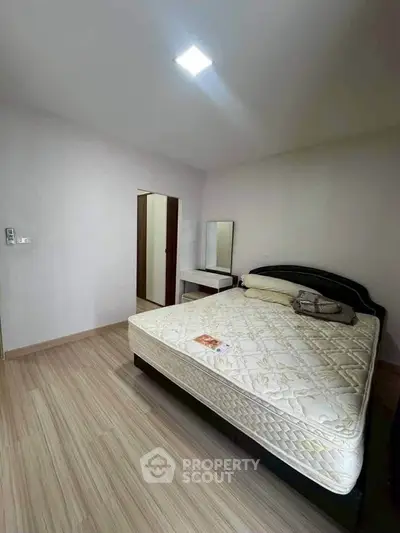 Spacious bedroom with modern decor and comfortable bed in a stylish apartment.