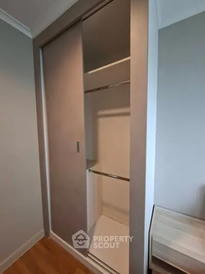 Modern built-in closet with sliding doors in a stylish bedroom