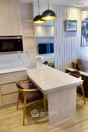Modern kitchen with sleek design and cozy dining area in a stylish apartment.