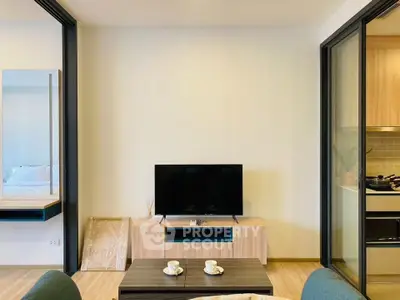 Modern living room with TV and open kitchen layout in stylish apartment