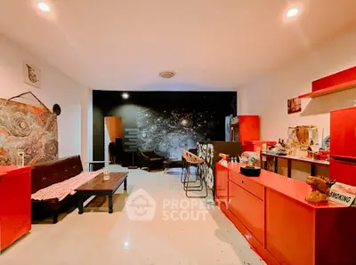 Stylish living room with vibrant red accents and modern decor