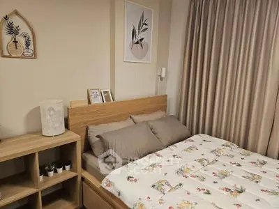 Cozy bedroom with stylish decor and wooden furniture, perfect for relaxation and comfort.