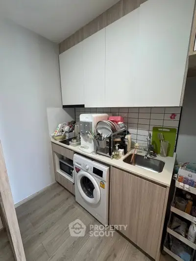 Compact kitchen with modern appliances and efficient storage solutions