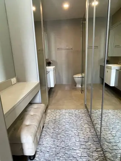 Modern bathroom with mirrored closet and plush stool