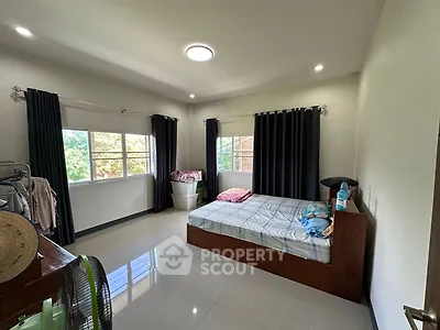 Spacious bedroom with large windows and modern decor