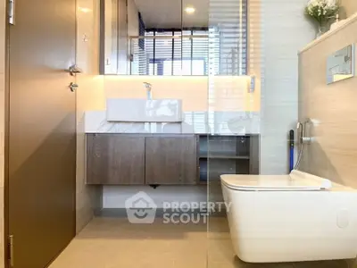 Modern bathroom with sleek fixtures and elegant design, featuring a floating vanity and contemporary toilet.