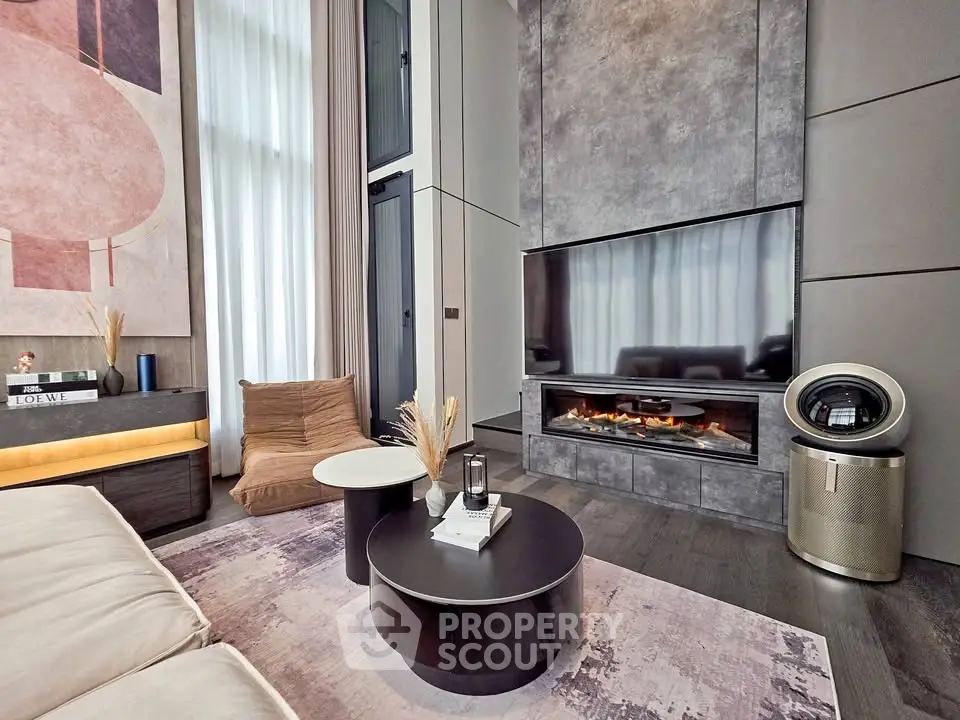 Luxurious modern living room with high ceilings, stylish fireplace, and elegant decor.