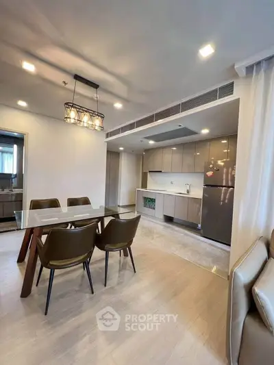 Modern open-layout kitchen and dining area with sleek design and contemporary furniture.