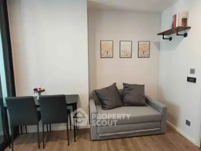 Modern living room with cozy gray sofa and elegant dining area, perfect for urban living.